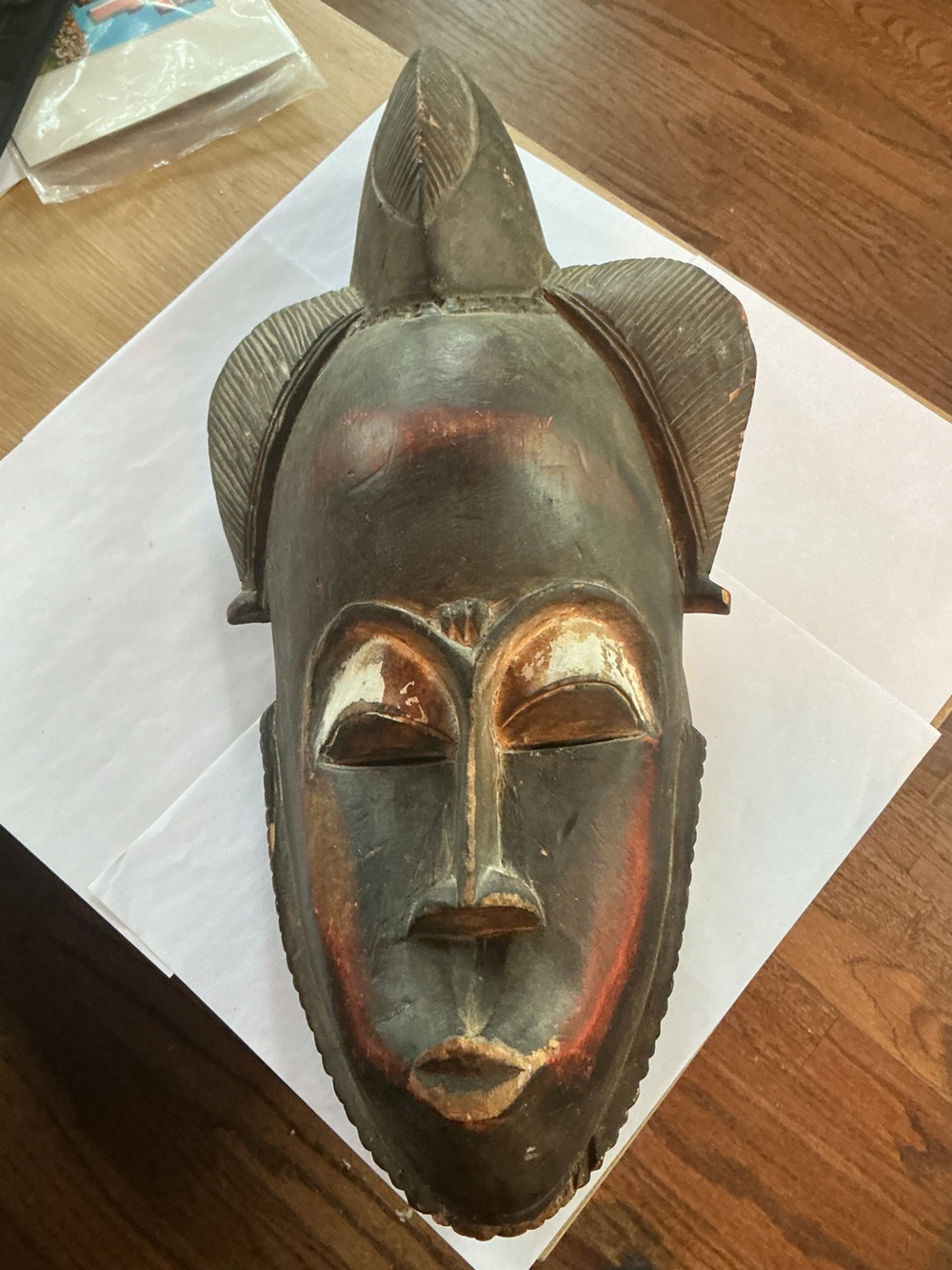 Hand-carved Baule tribal wooden mask from the Ivory Coast.